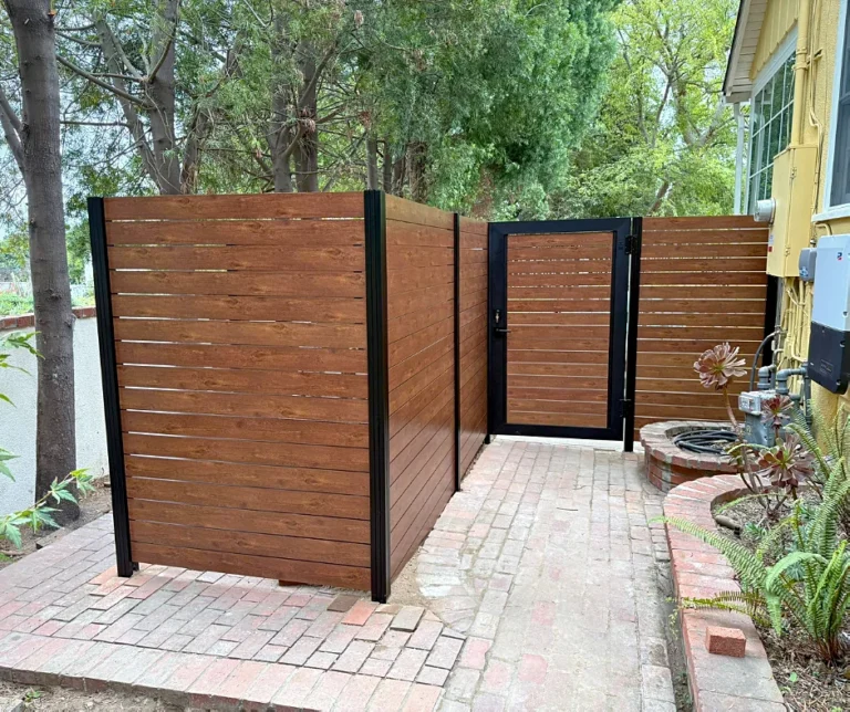 Wood grain ALU40 fence and gate over brick pavers
