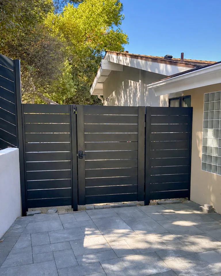 ALU40 black gate and fence enclosing a courtyard