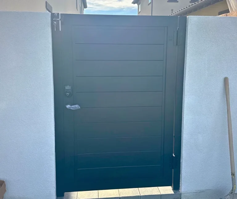 ALU60 full privacy black gate over a concrete walk
