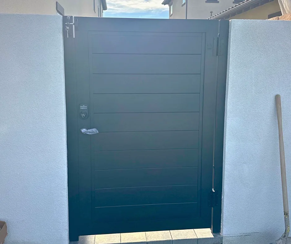 ALU60 full privacy black gate over a concrete walk