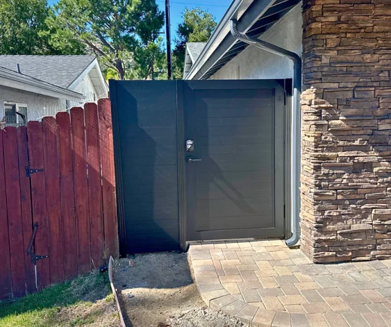 ALU60 black gate beside a stone column