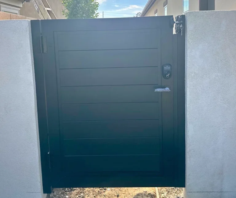 ALU60 full privacy black gate between stucco walls