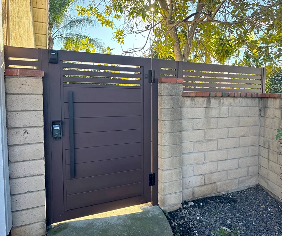 ALU60 bronze gate with slatted top beside a block wall