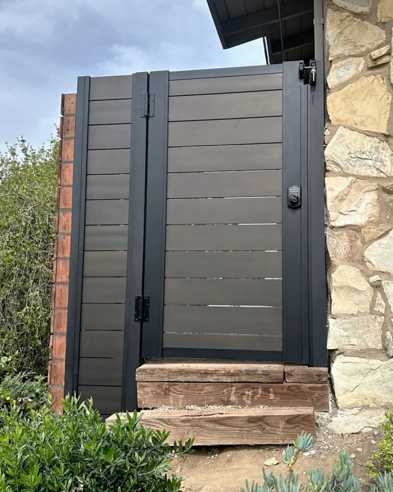 ALU60 T&G full privacy gate beside a stone wall
