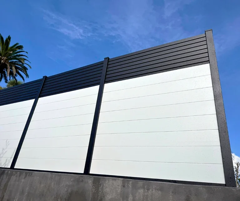 Close-up of a white T&G fence with black top rail
