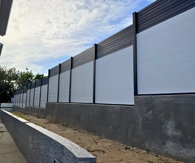 White T&G fence on a retaining wall