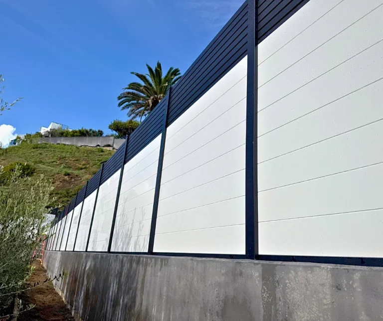 White T&G fence on a stepped wall