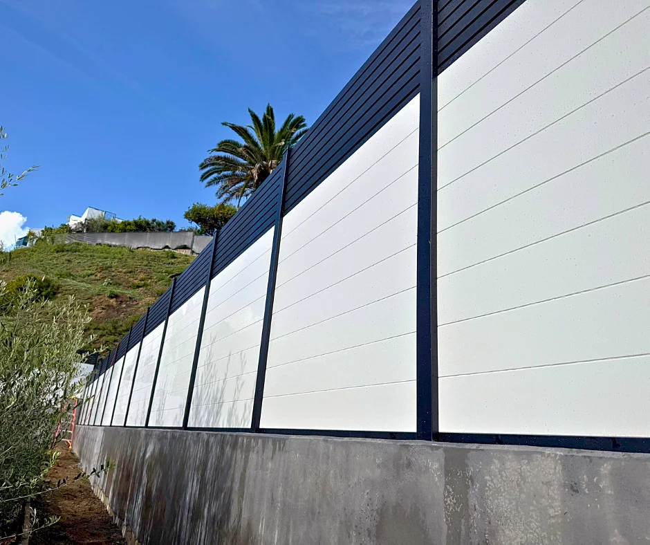 White T&G fence on a stepped wall