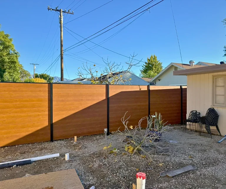 Wood grain ALU60 T&G privacy fence around a backyard