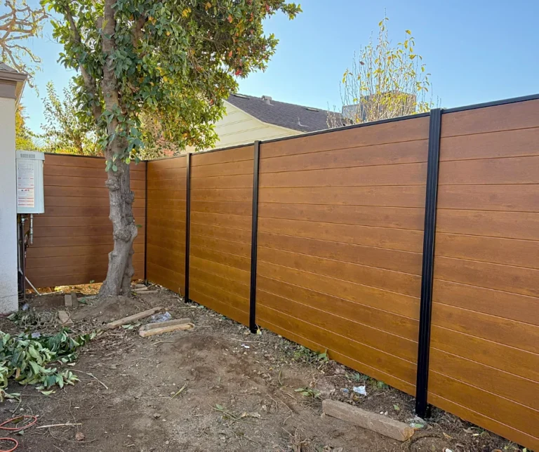 Wood grain ALU60 T&G privacy fence in a side yard