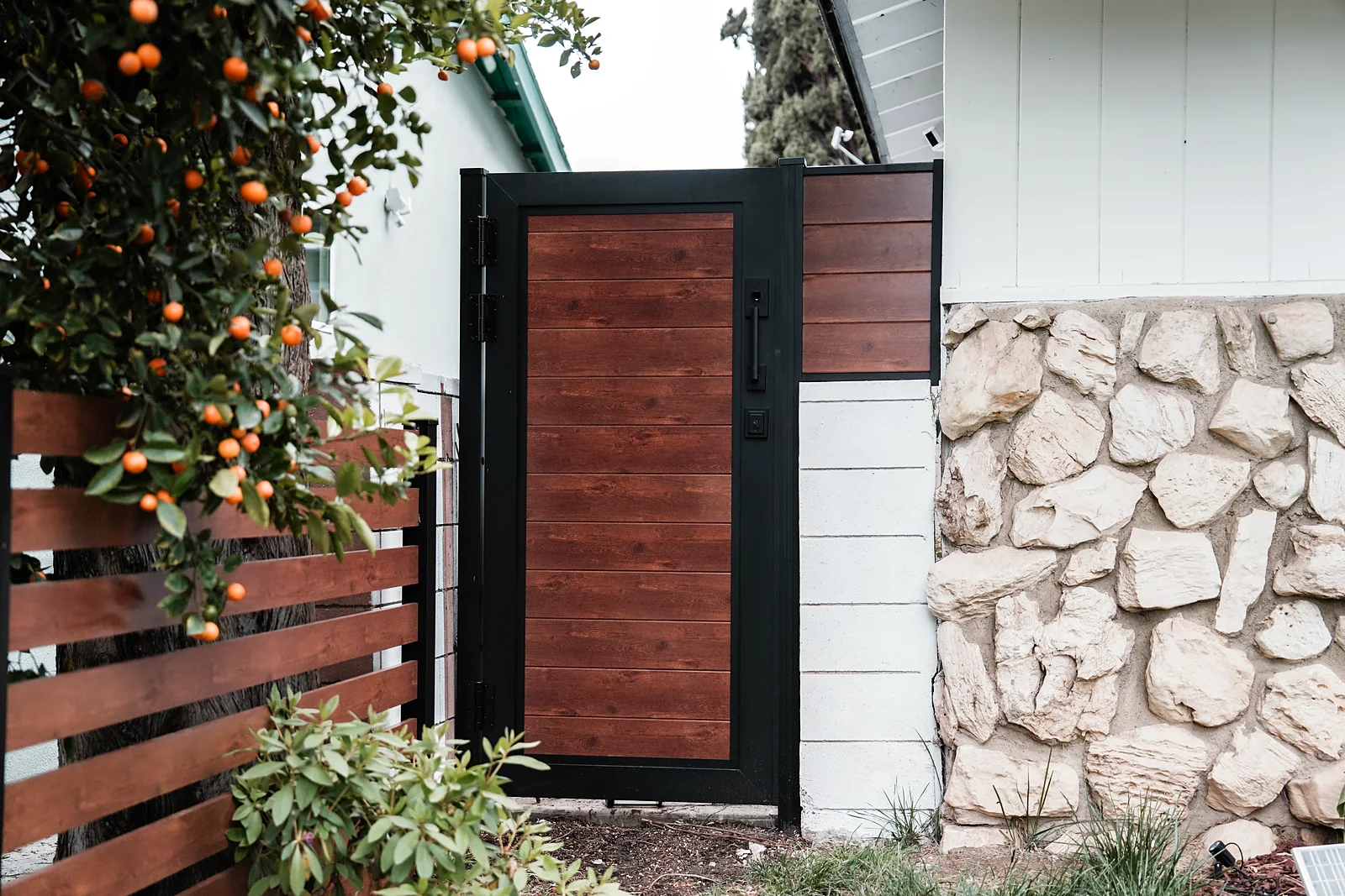 ALU60 T&G woodgrain gate beside a stone wall