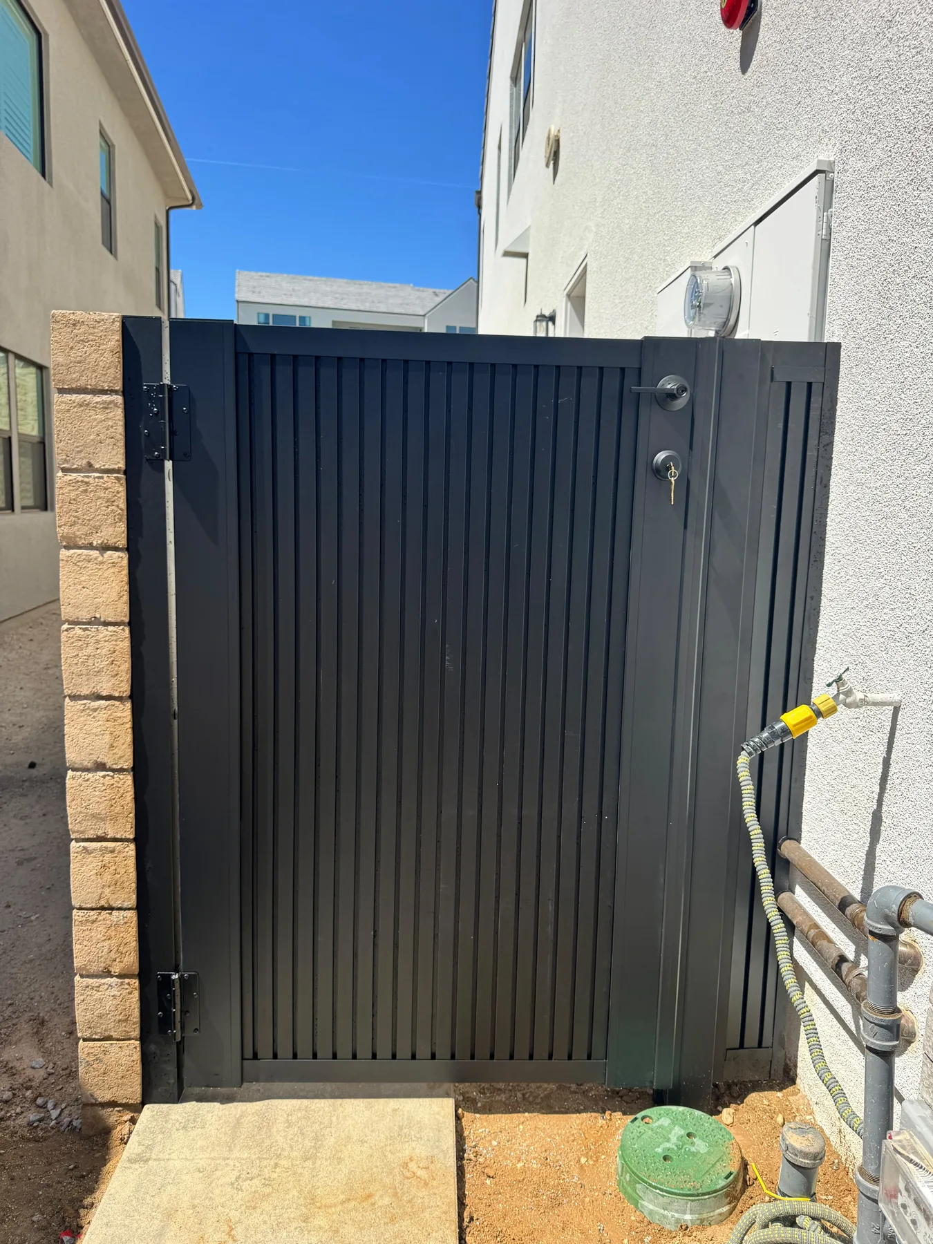 Black aluminum cladding gate in a side yard