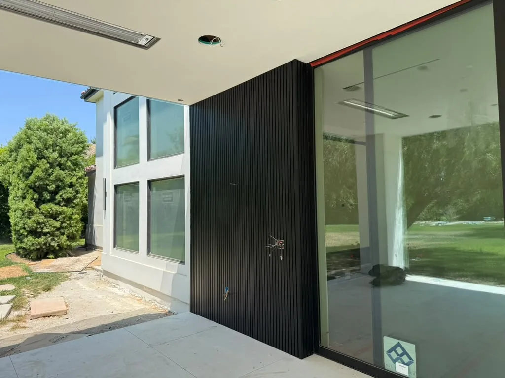 Black aluminum cladding beside a glass wall
