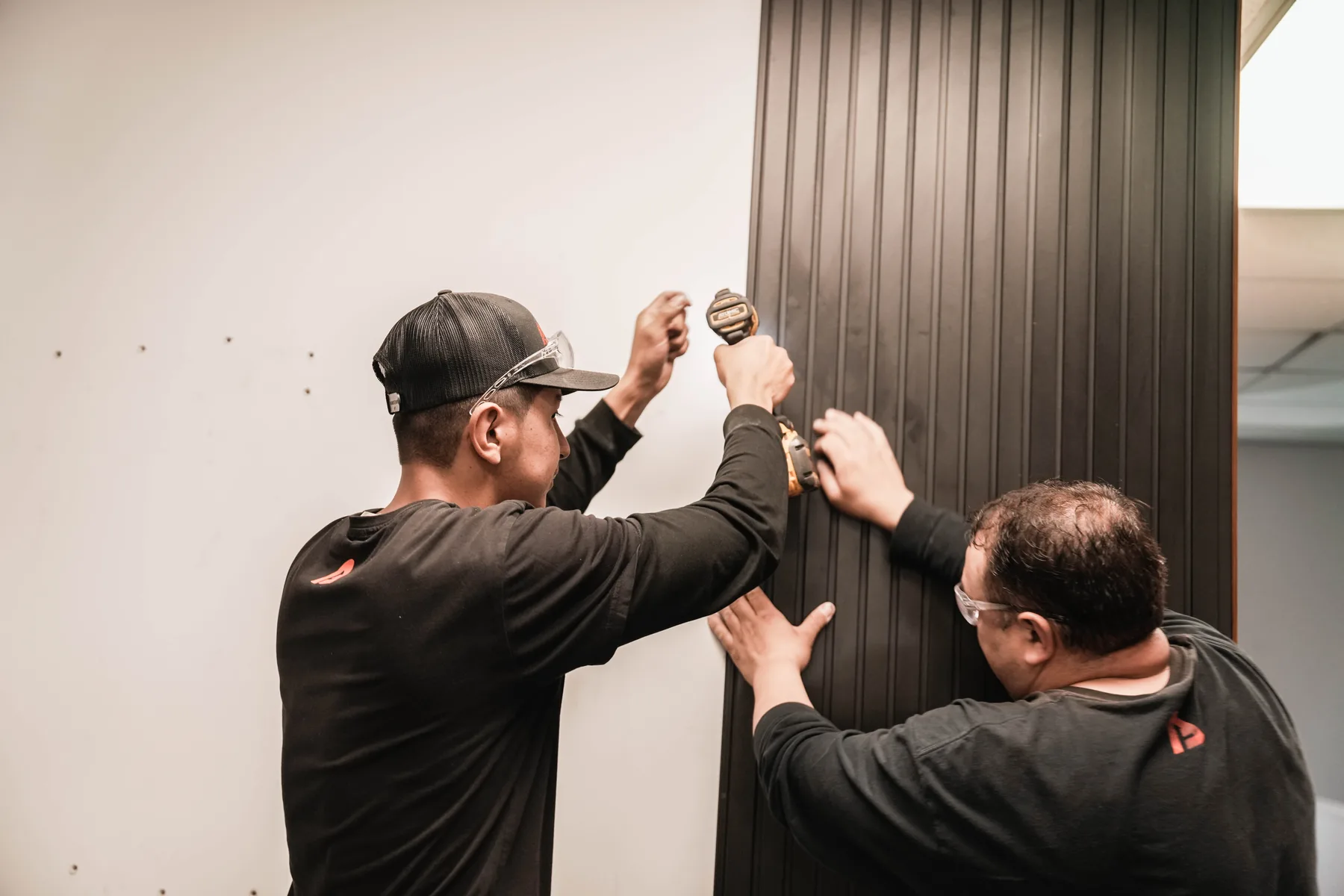 Aligning aluminum cladding panels on a wall