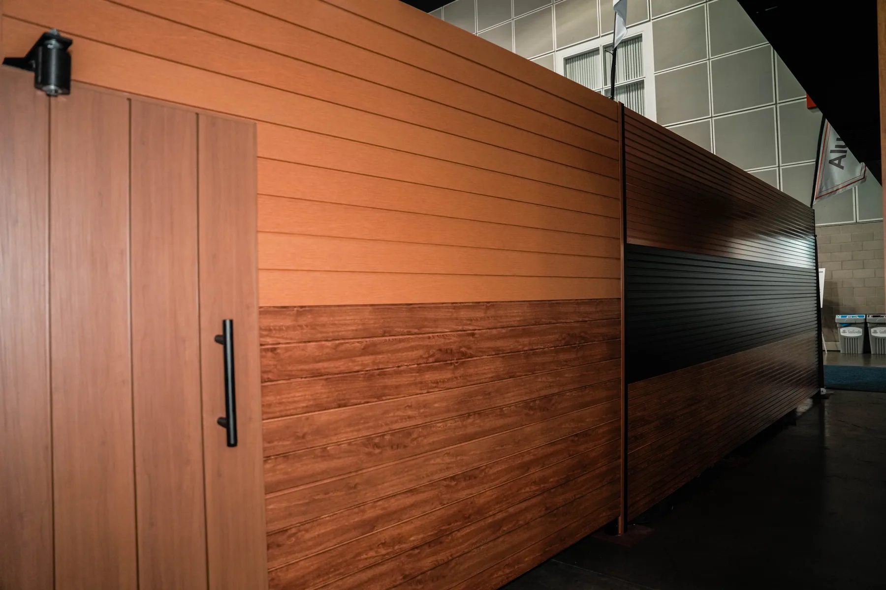 Woodgrain and black cladding walls with a matching door