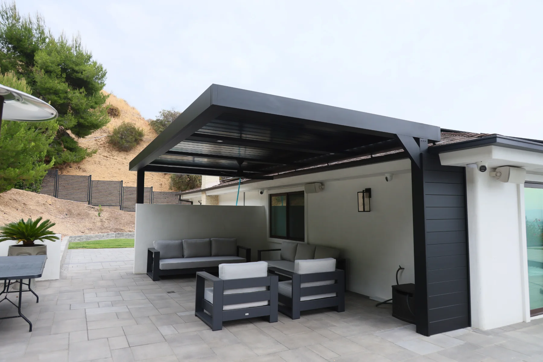 Black louvered patio cover with lounge seating, Burbank