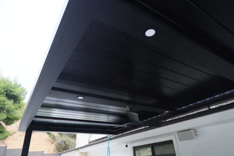 Underside of a black louvered roof with recessed lighting