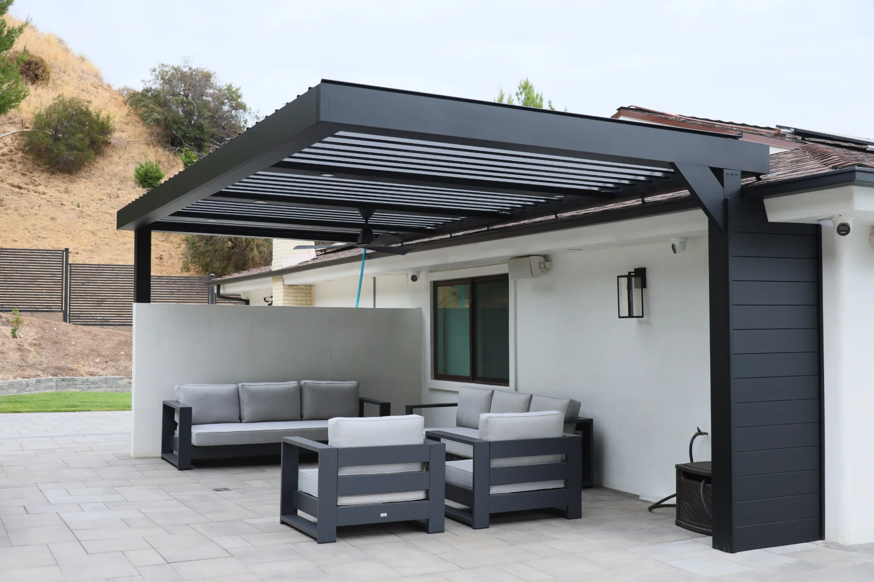 Louvered patio cover with louvers angled open