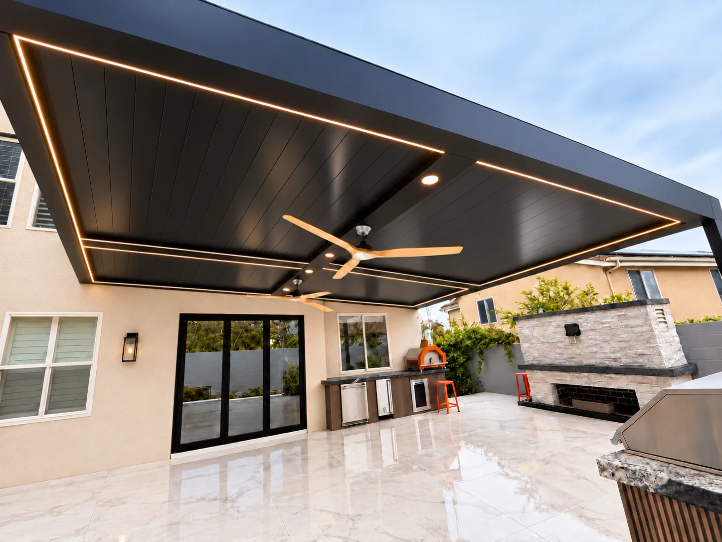 ALU FORTIS patio cover in black with a black slatted ceiling and LED lighting