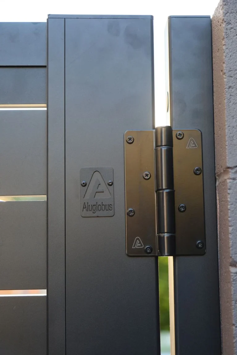 Black hinge on an aluminum gate frame