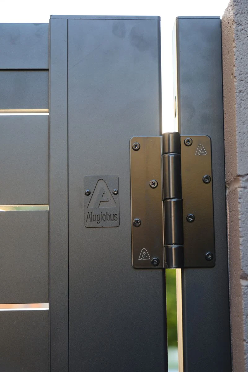 Black hinge on an aluminum gate frame