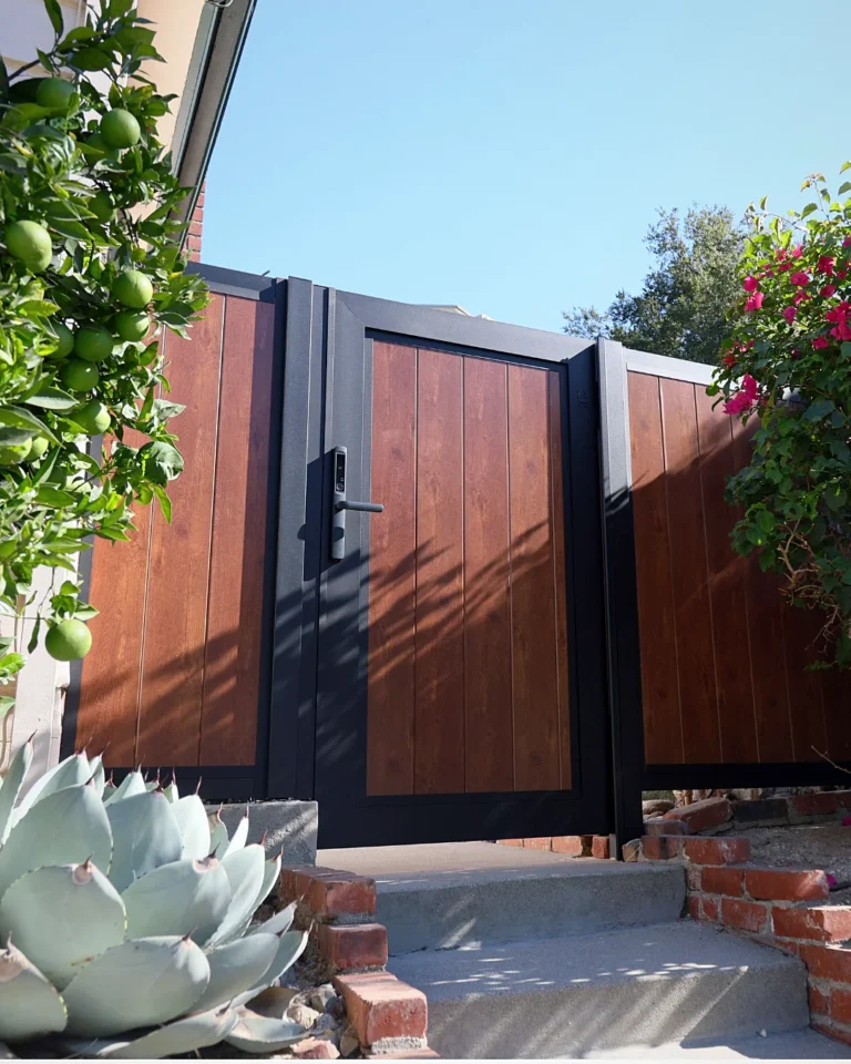 Vertical wood grain aluminum gate at a garden entry