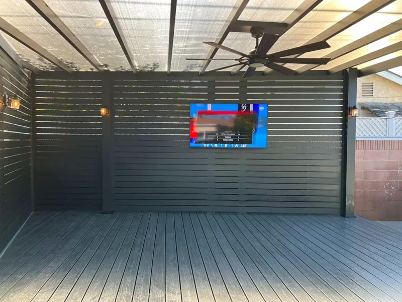 Aluminum beam patio cover with a clear roof, slat privacy walls and a TV wall