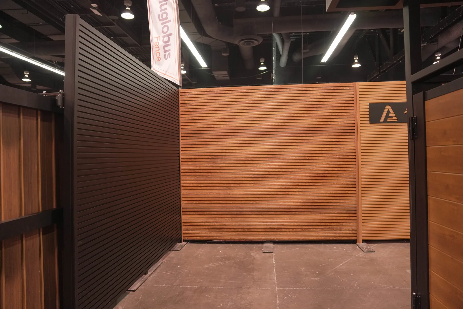 Horizontal woodgrain cladding next to black vertical cladding