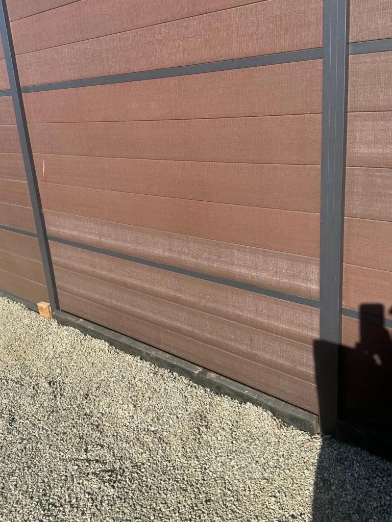 Not an Aluglobus product. Field photo: composite fence boards fading near the ground