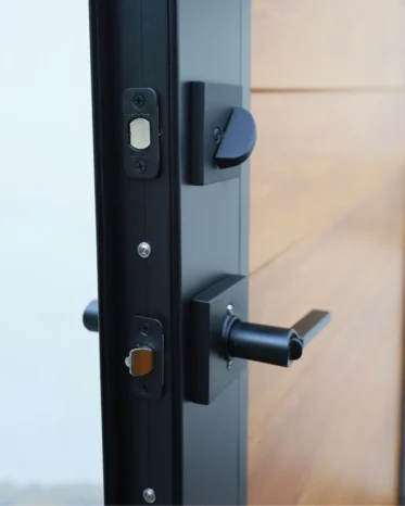 Heavy-duty black aluminum framed privacy pedestrian gate featuring realistic wood grain infill panels.