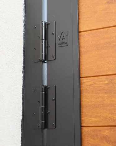 Matte black vertical center cover strip featuring keyed handle lock and bottom ground drop bolt.