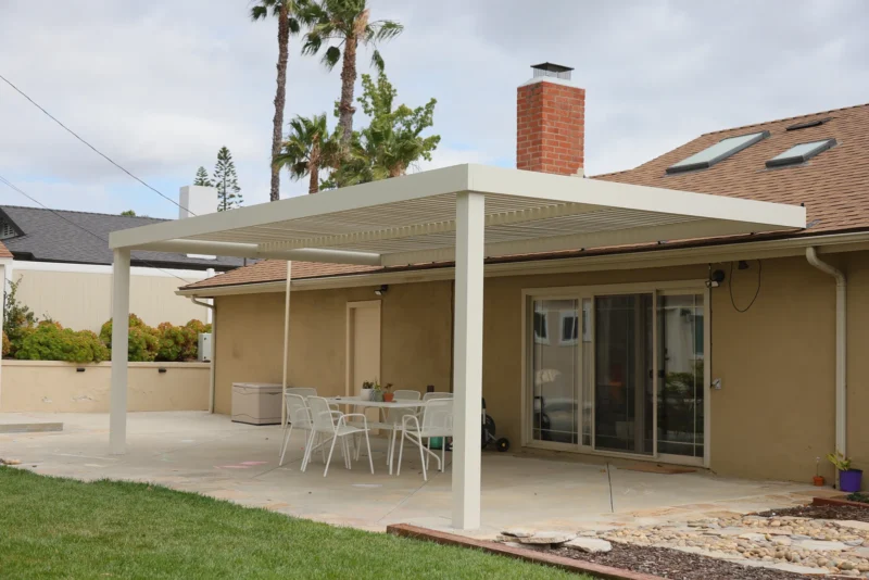 White slat patio cover over an outdoor dining area